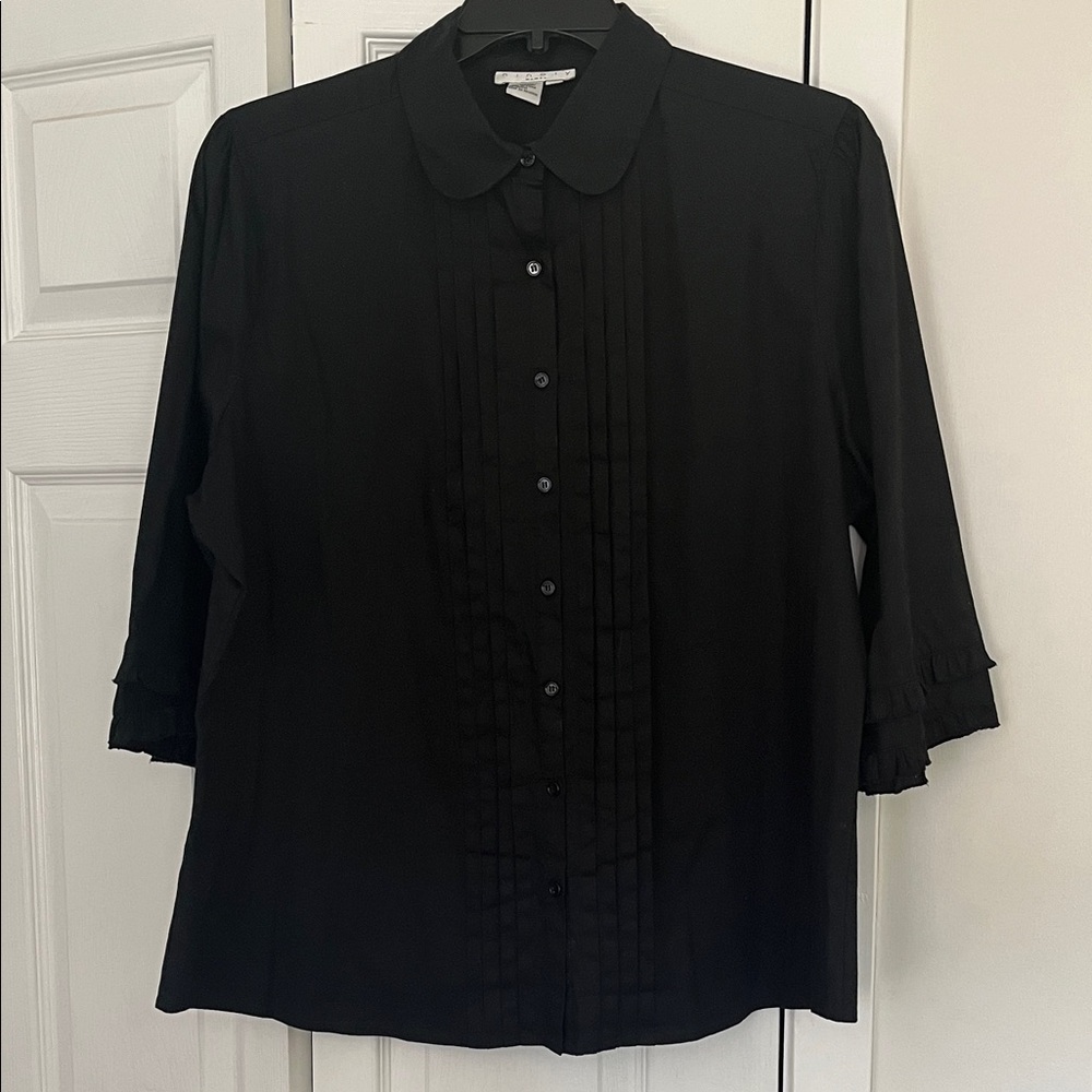 Black blouse size 2X with a pleated front and ruffled 3/4 sleeves.